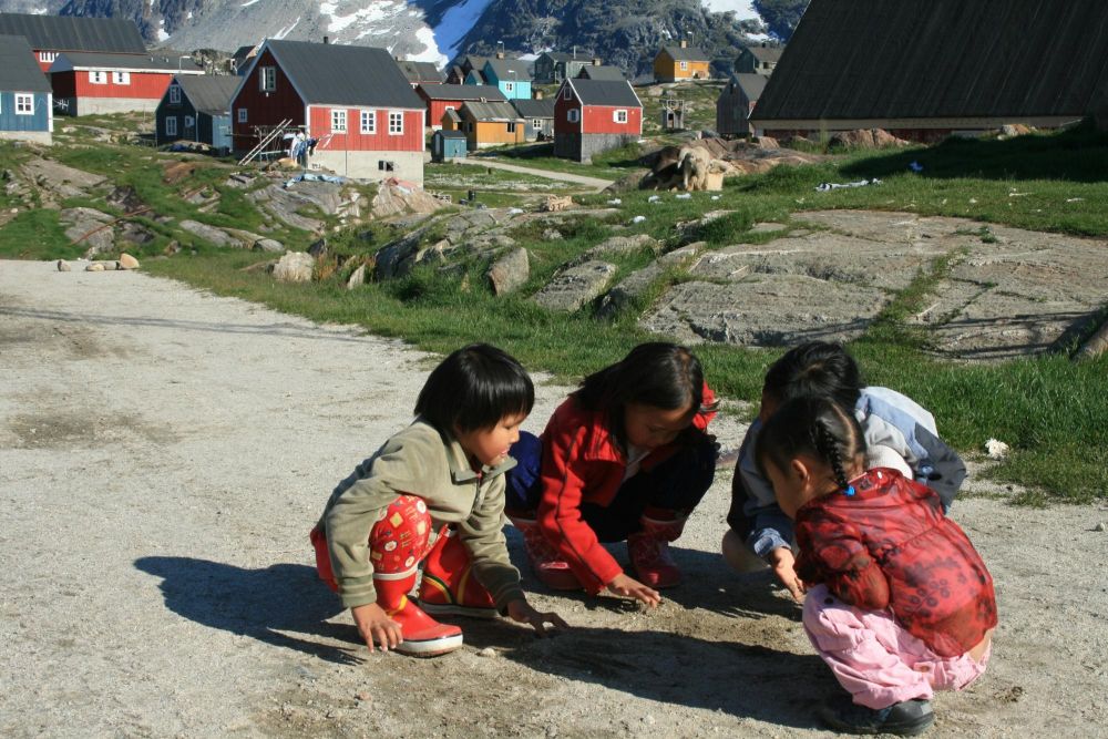 Enfants du village de Kuummiut jouant aux billes